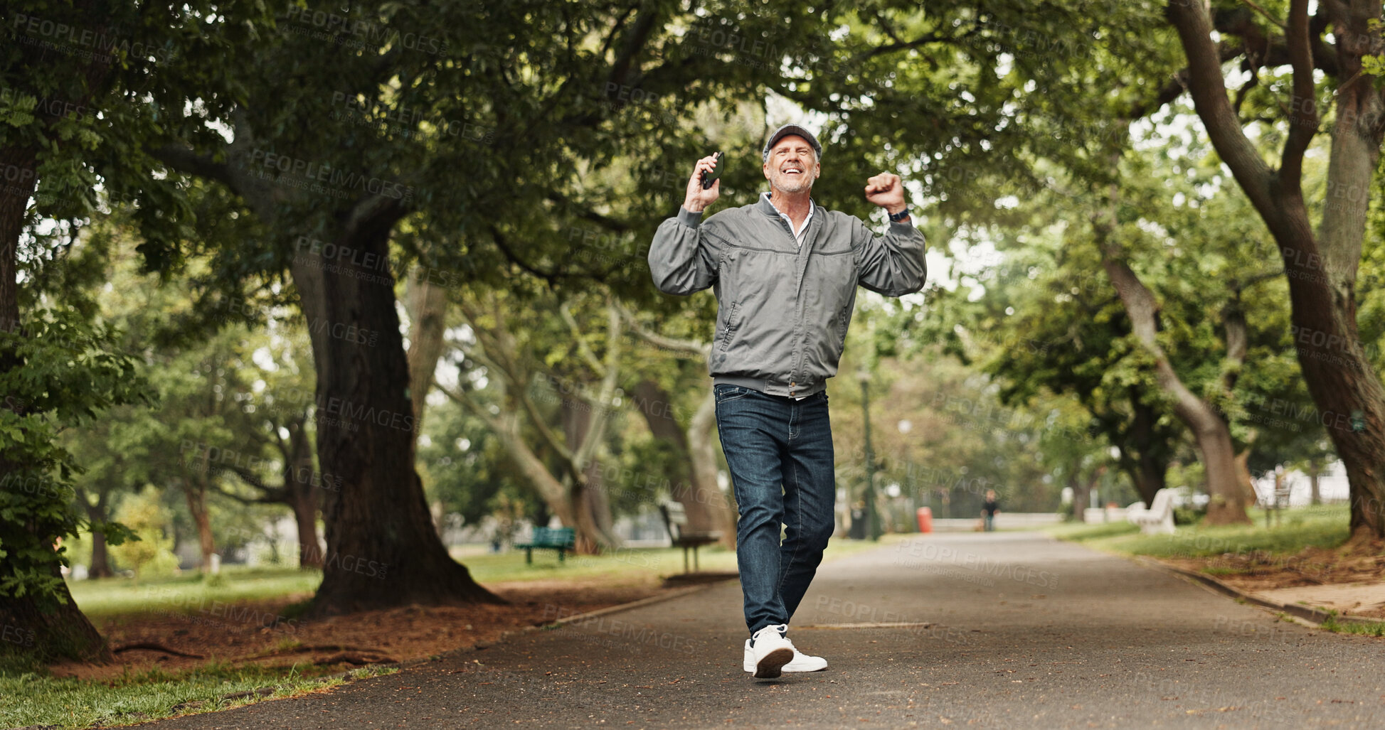 Buy stock photo Senior, happy man and dancing with phone at park for good news, winning or celebration in retirement. Mature, excited or male person with mobile smartphone for prize, pension or free time in nature