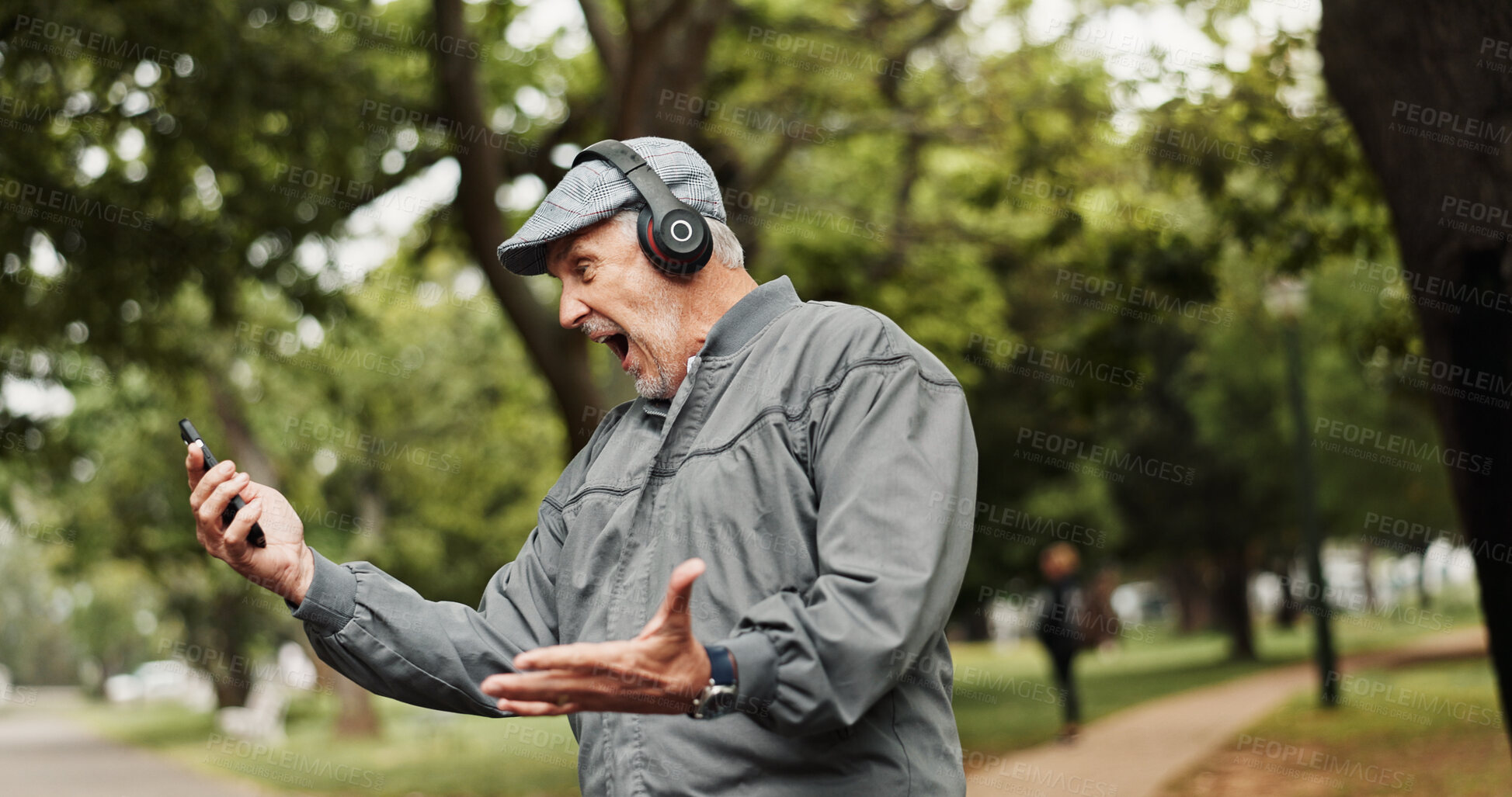Buy stock photo Headphones, senior man and excited with phone in park for good news, giveaway winner and gambling bonus. Old person, smartphone and celebration for lottery prize, competition notification or shouting