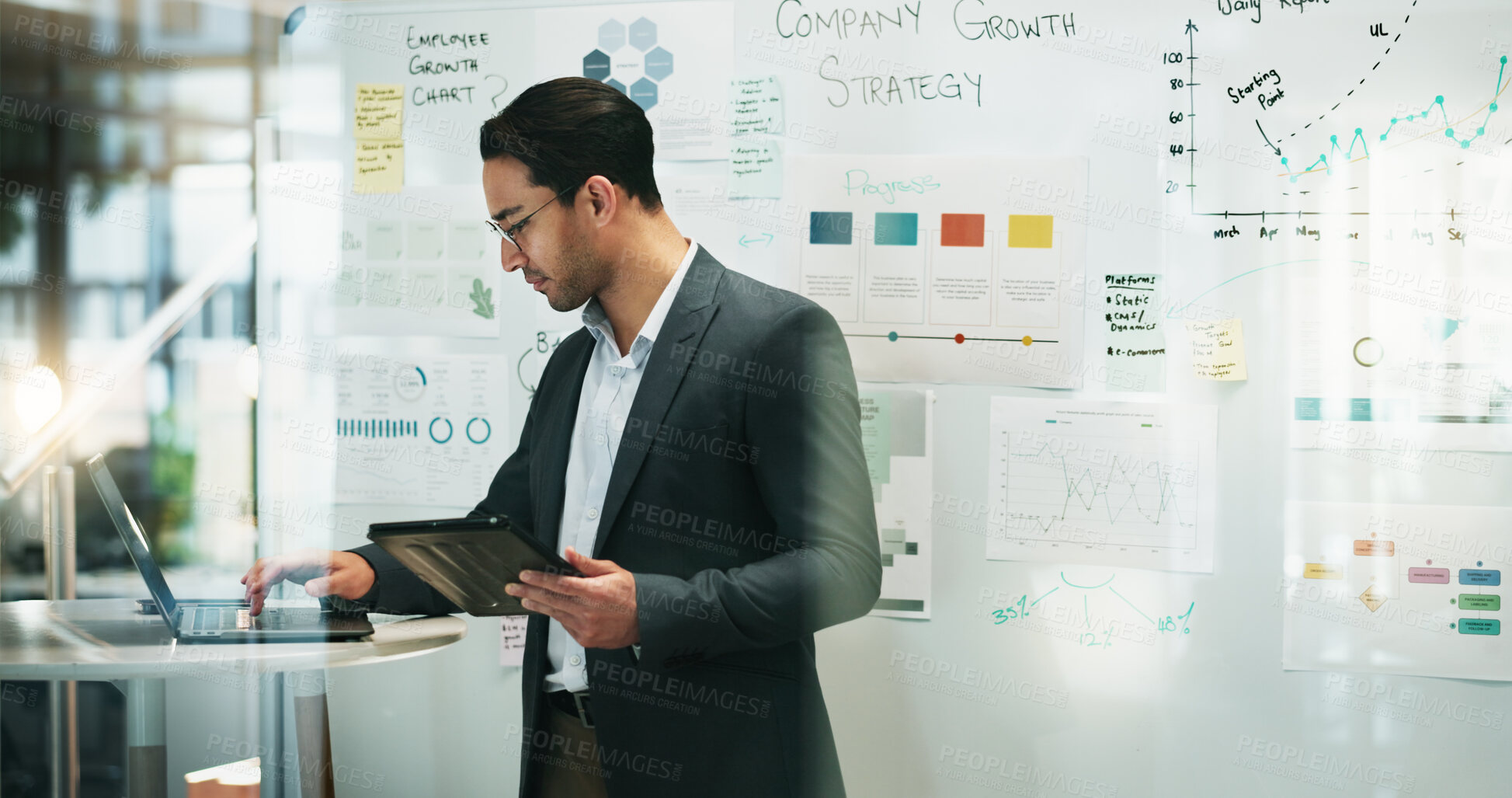 Buy stock photo Business, man and laptop with tablet at office for research, strategy and information on company growth as accountant. Male person, employee and serious with report or revenue for budget and solution