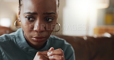 Buy stock photo Crying, sad and black woman with depression, thinking or psychological trauma in home living room. Tears, unhappy or African person with anxiety for crisis, mental health challenge or stress for ptsd