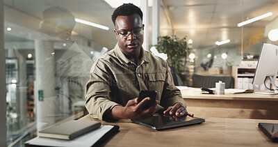 Buy stock photo Black man, office and phone text at night with stress, deadline and burnout of employee. Reading, anxiety and professional contact with media project and brand deal planning with tech at work desk
