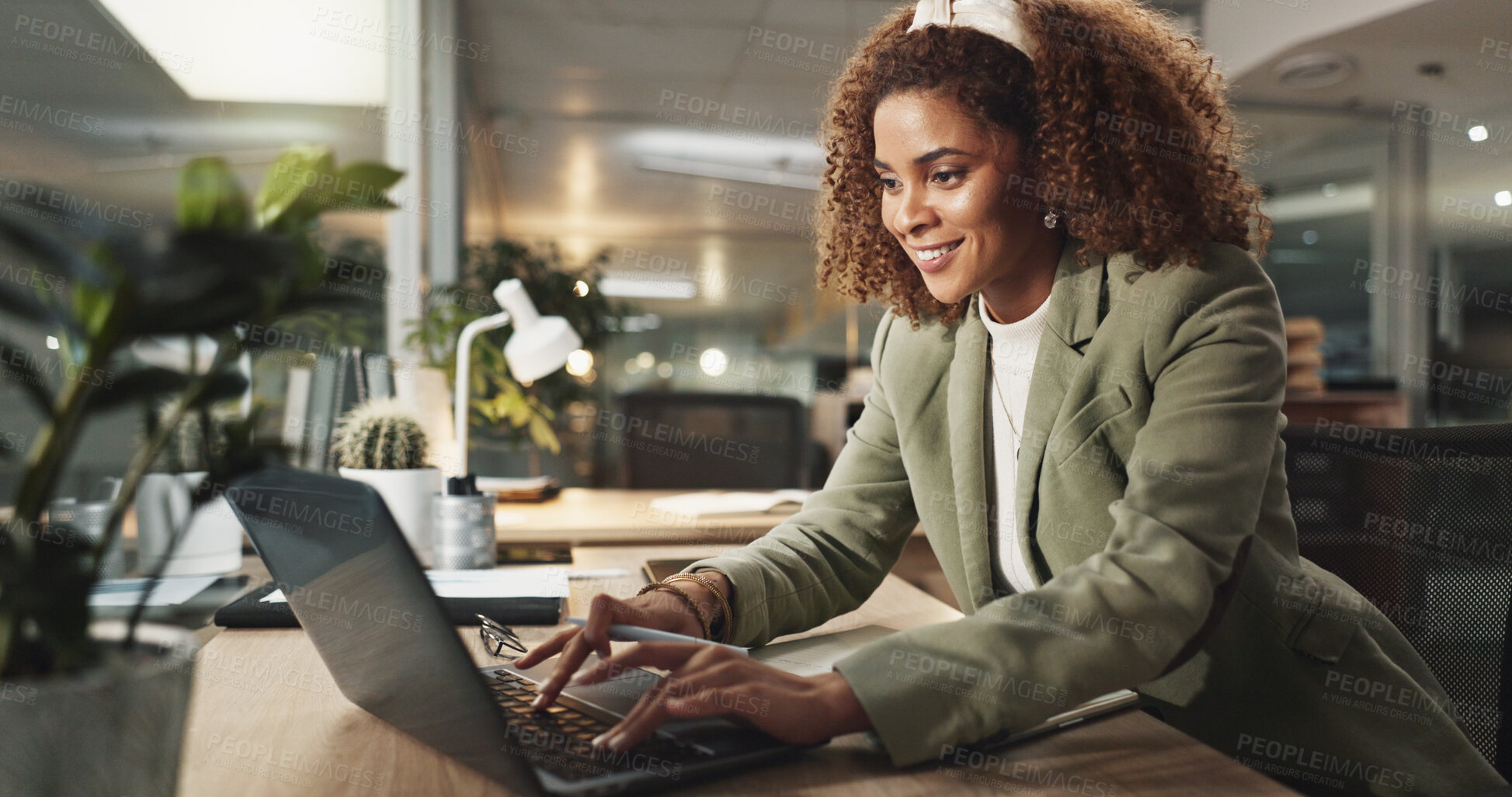 Buy stock photo Laptop, happy businesswoman and typing at night for report, magazine publication or deadline in startup office. Computer, writing and African worker with project, reading email or creative feedback