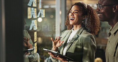 Buy stock photo People, tablet and happy at glass for planning, deadline progress and sticky notes at night. Business team, tech and laugh in dark office for productivity, project development and ideas on window