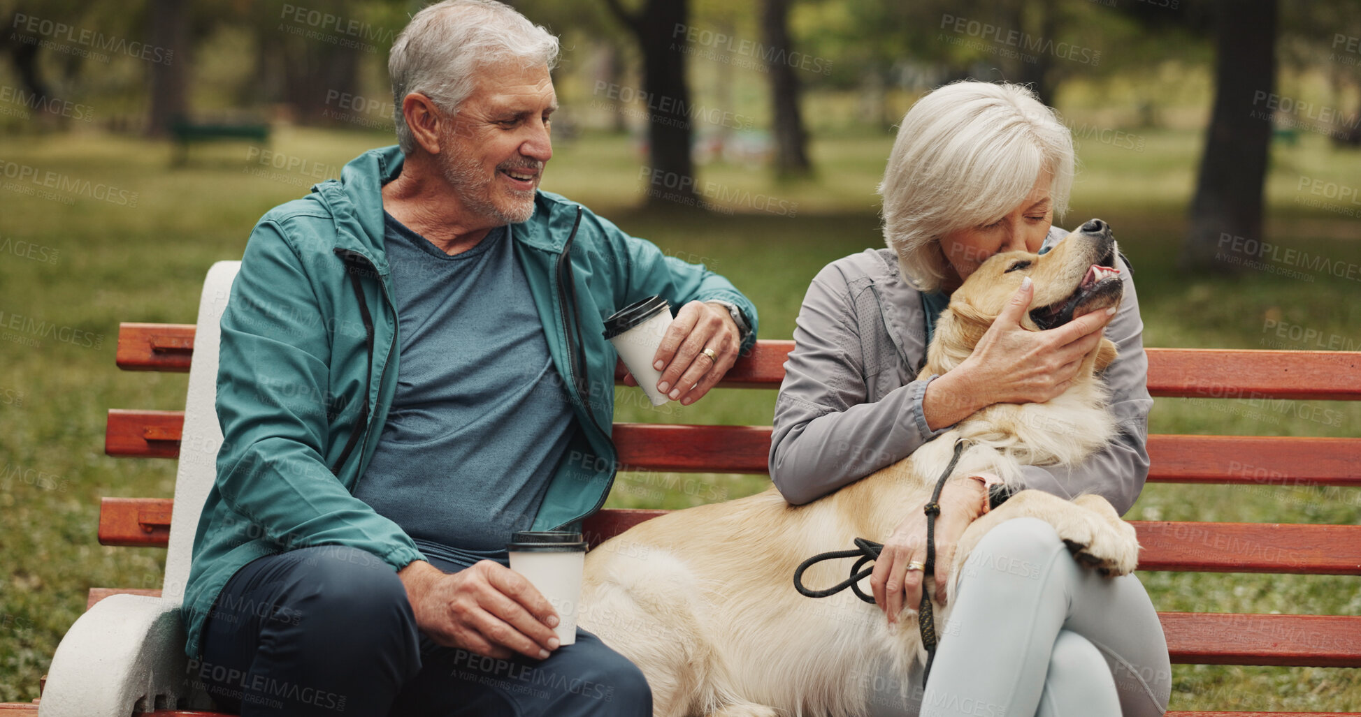 Buy stock photo Dog, park and old couple on bench, hug and relationship with animal lover. Outdoor, pet and happy senior man with mature woman, bonding together and conversation with embrace, smile and retirement