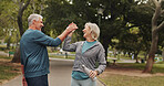 High five, senior couple and park for fitness goals, happy for wellness win with workout and bottle for water. Success, support and exercise, man and woman for retirement bonding outdoor with drink