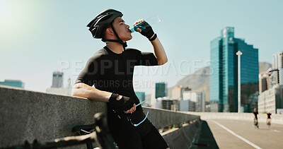 Buy stock photo Drinking water, training and cycling with man in city for triathlon challenge, electrolytes and workout. Wellness, exercise and competition with person and bike for sports, fitness and cardio