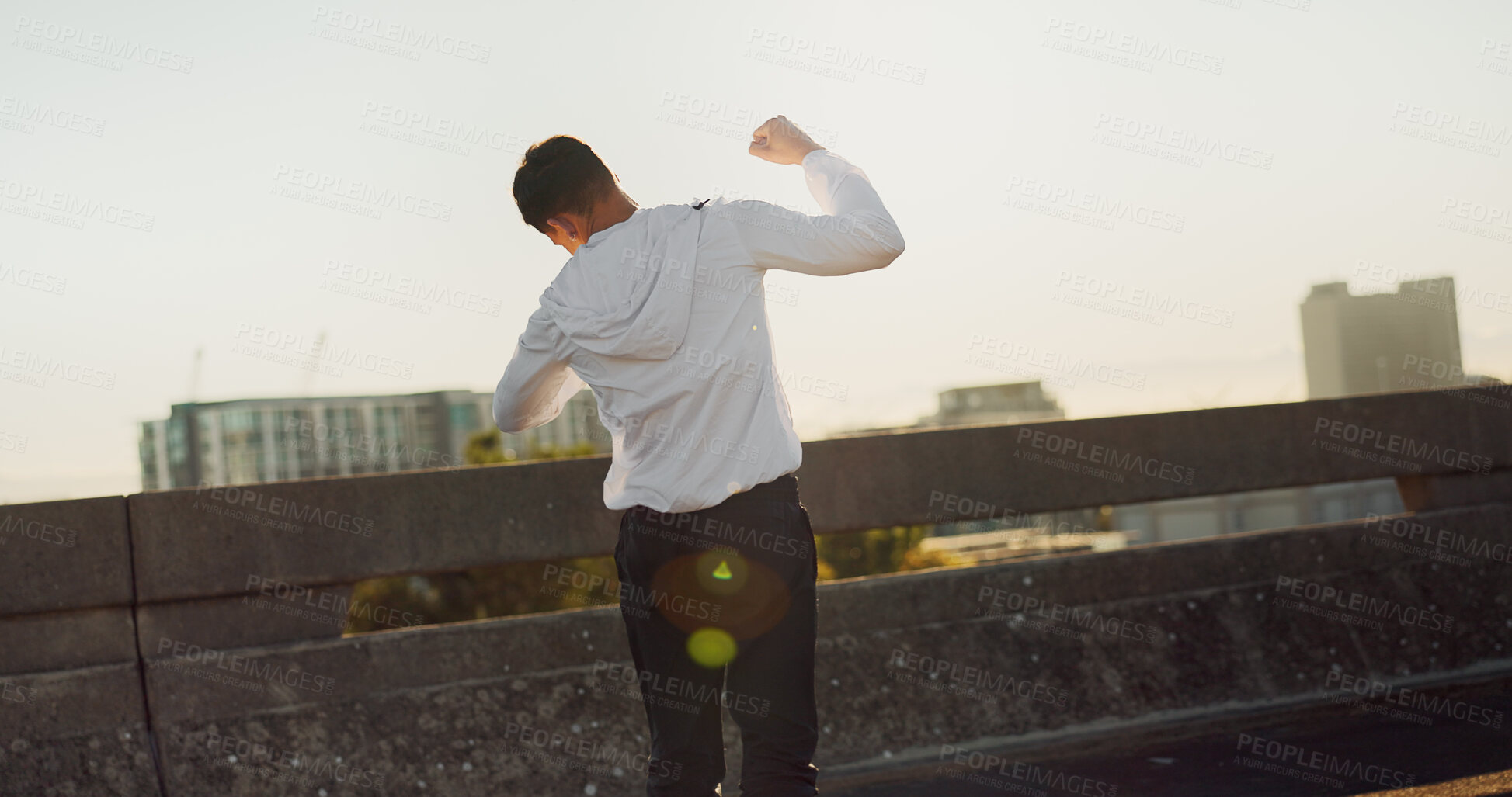 Buy stock photo Back, athlete and man with celebration outdoor for workout success, exercise achievement and marathon goals. Fitness, person or victory fist on bridge for training milestone and pride for performance