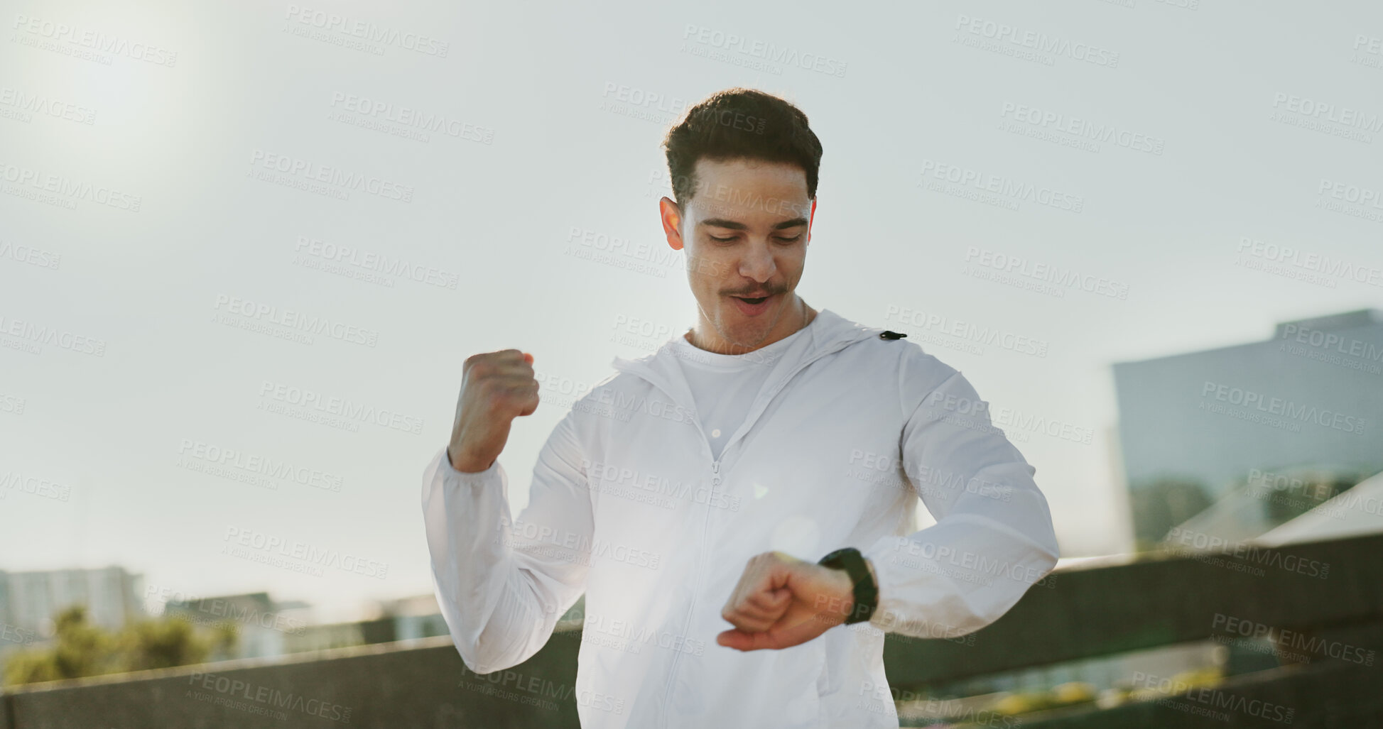 Buy stock photo Man, runner and smart watch with celebration in city with smile for goals, challenge and timer for speed. Person, athlete and check stopwatch on bridge for workout, progress and cheers in Costa Rica