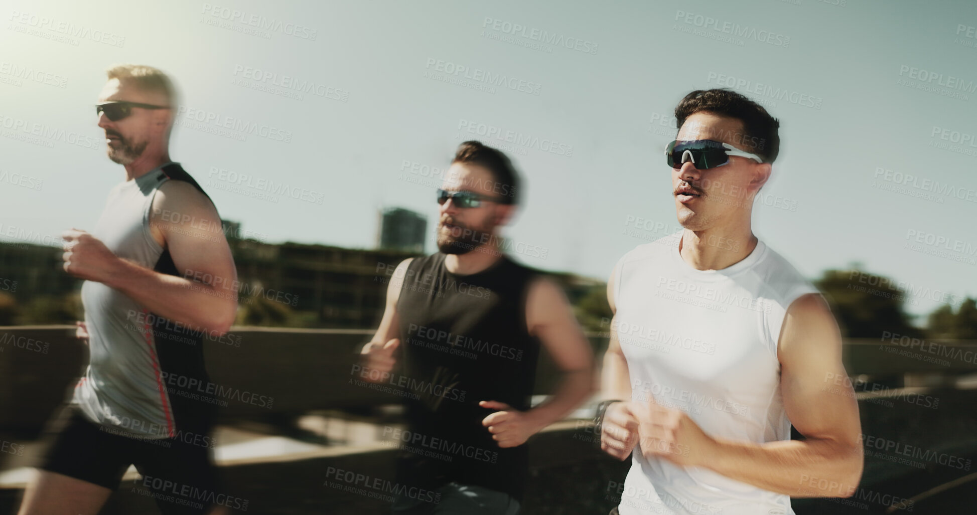 Buy stock photo Fitness, men and running in city with speed, motion and cardio challenge in group. People, friends and marathon training on bridge with endurance, fast exercise or resilience with commitment to sport