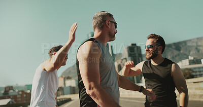 Buy stock photo Men, fitness and friends celebrate in city for race, running challenge and marathon training. High five, success or excited male athletes in cardio exercise or workout on bridge or road with teamwork