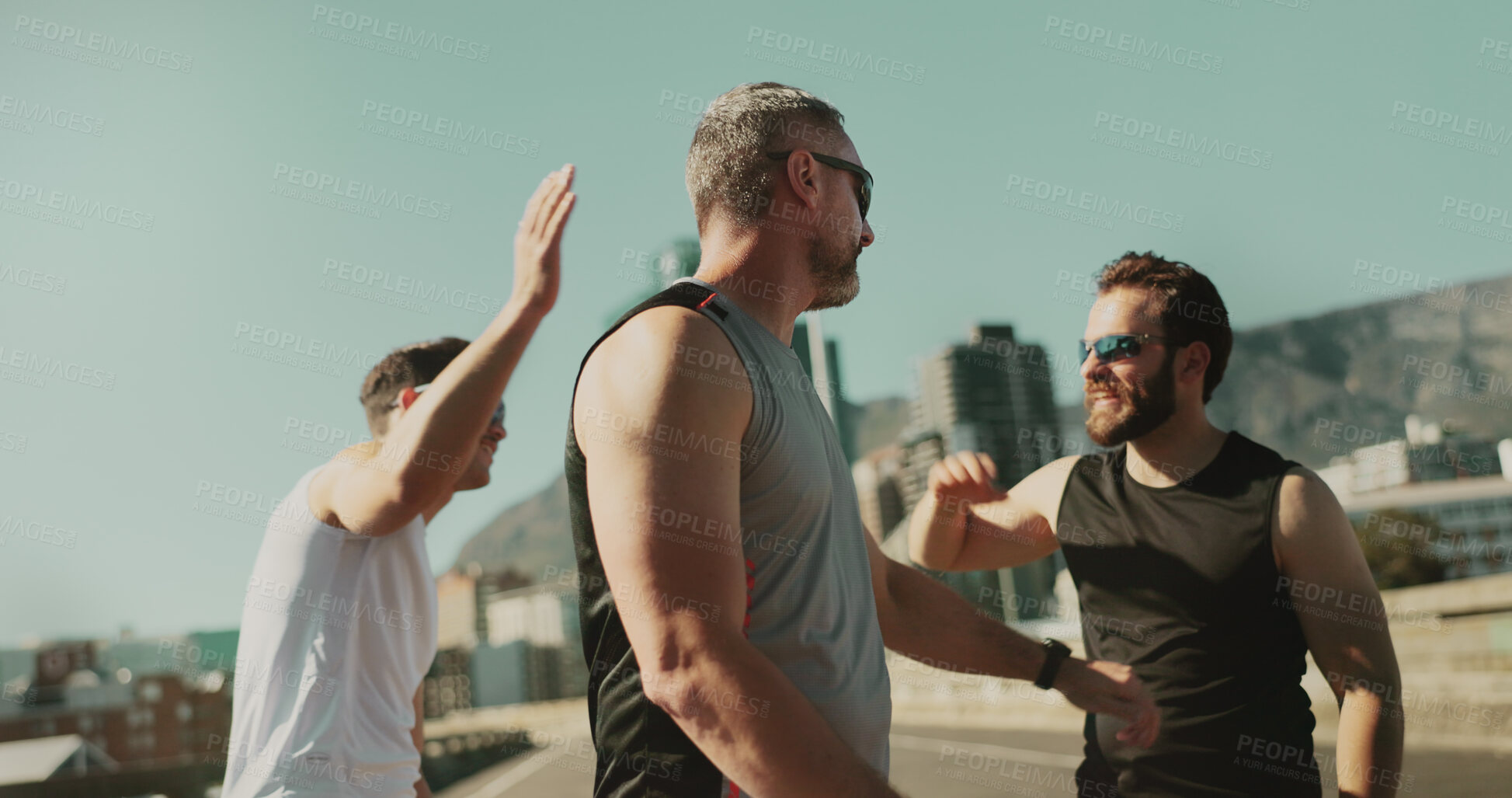 Buy stock photo Men, fitness and friends celebrate in city for race, running challenge and marathon training. High five, success or excited male athletes in cardio exercise or workout on bridge or road with teamwork