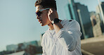 Fitness, earbuds and man in city, training and runner with audio, listening to music and exercise. New York, person and athlete in street, sunglasses and workout with radio and podcast for motivation