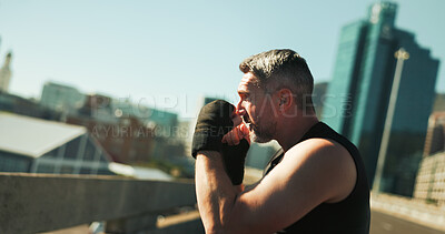 Buy stock photo Man, boxer and gloves of fitness outdoor with sports exercise, boxing workout and fight performance. Athlete, male person and fist of mma training, defence challenge and match practice on city bridge