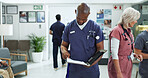 File, man and doctor in hospital with healthcare report, research or feedback on postop. Medical folder, reading and male surgeon with surgery or treatment plan approval document in clinic lobby.