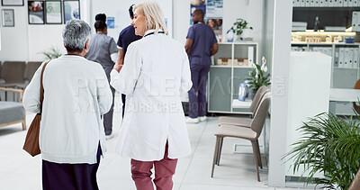 Buy stock photo Doctor, back and walking with old woman in hospital for meeting, diagnosis and healthcare results. Support, advice and report with people in clinic for medical exam, life insurance and patient