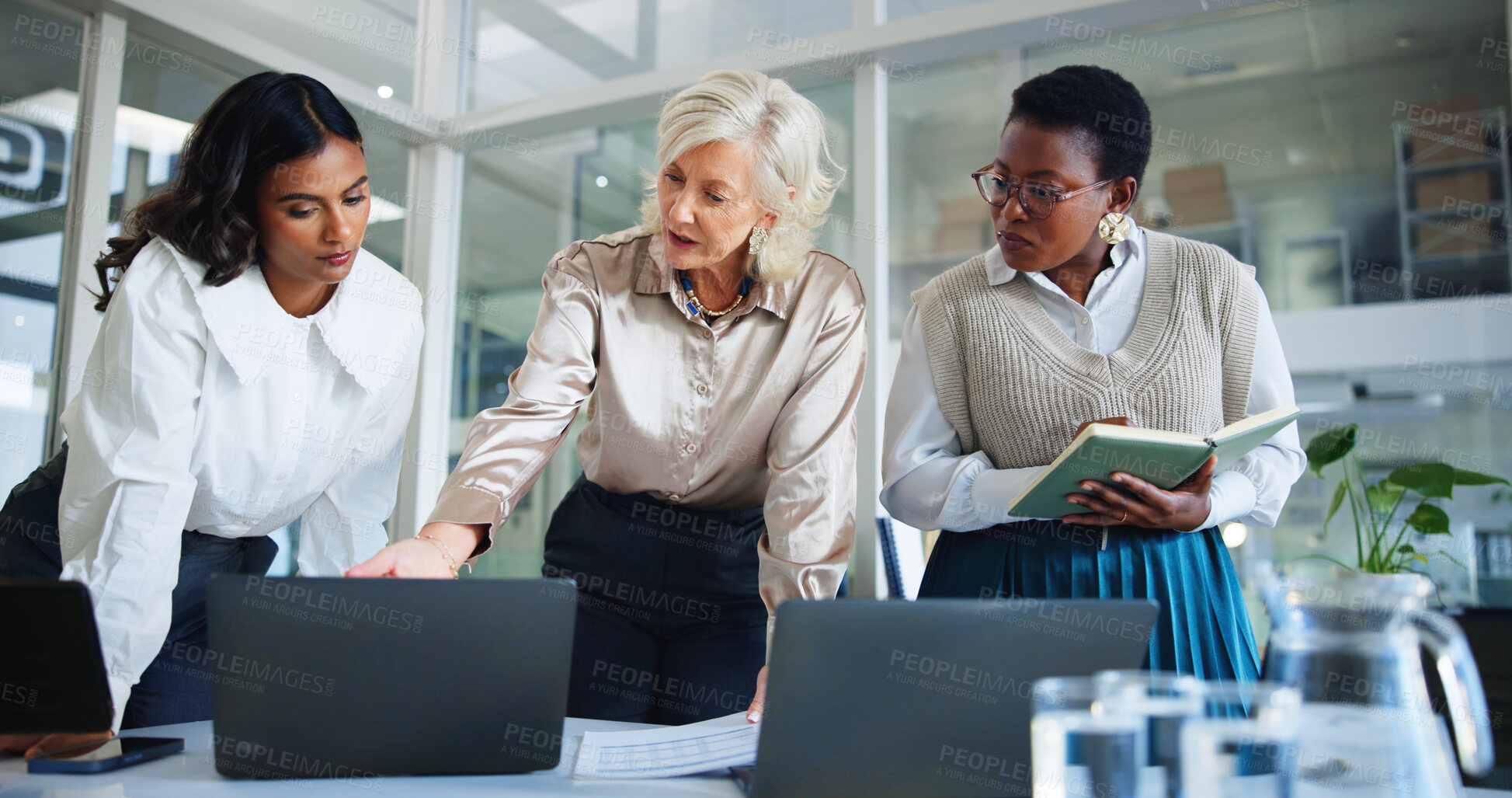 Buy stock photo Business women, meeting or discussion with laptop for project management, planning or collaboration at office. Female people, employee or colleagues working on computer for online report at workplace