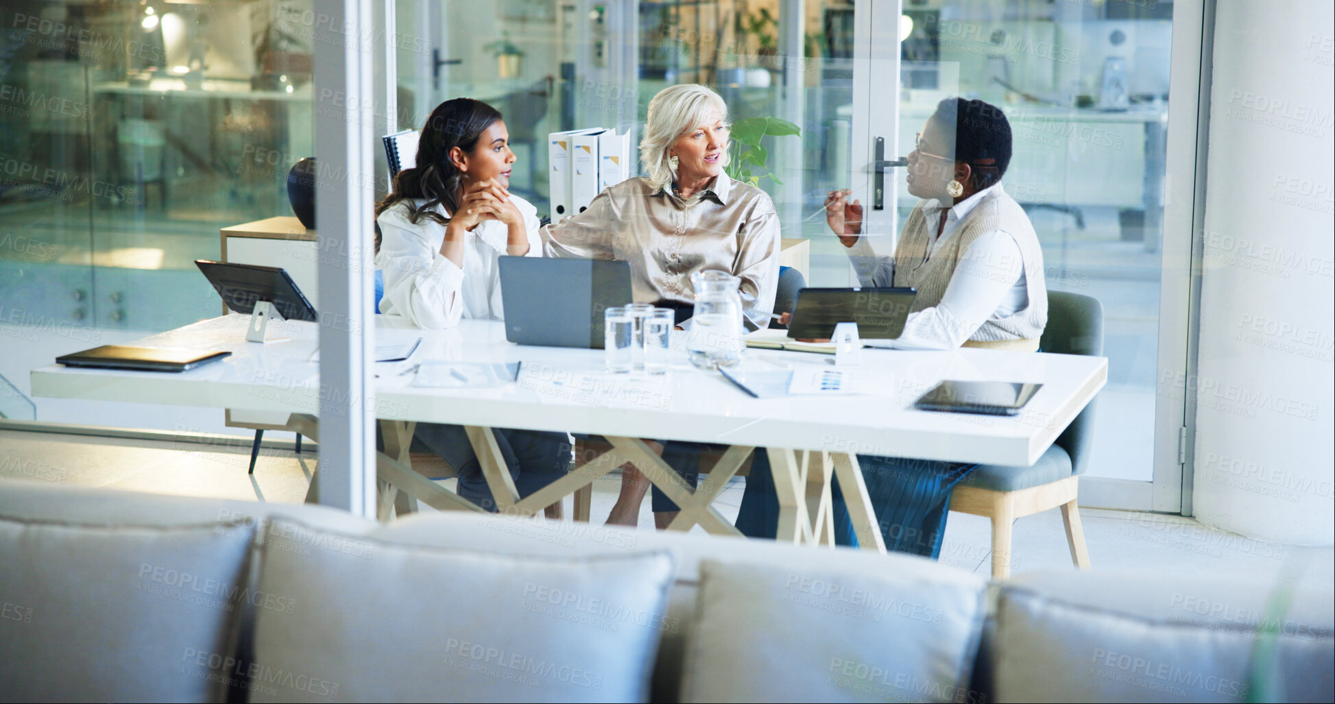 Buy stock photo Business women, meeting and discussion with team for planning, project or strategy at office. Female people, employees or colleagues talking with technology for company improvement or development