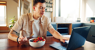 Buy stock photo Man, fruit salad and laptop in home, breakfast and relax with video streaming, subscription and meal in kitchen. Person, eating and computer with food, nutrition and diet on social media at apartment