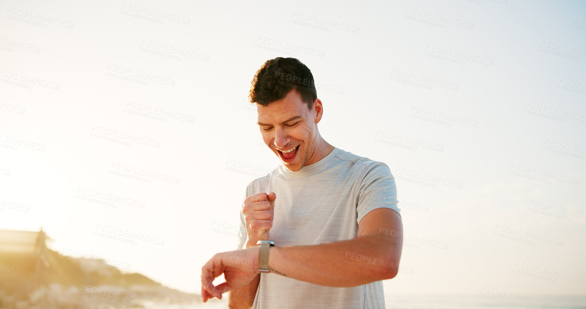 Buy stock photo Happy man, fitness and smart watch with sunset by beach for workout achievement, exercise goals or accomplishment. Active, male person or runner with smile or wristwatch for training success by ocean