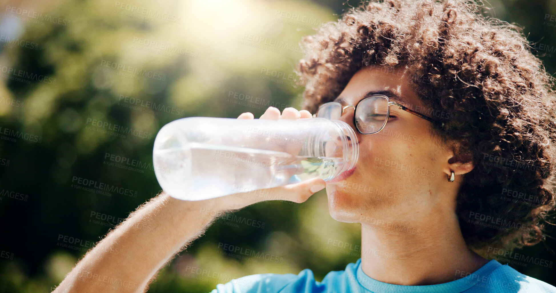 Buy stock photo Drinking water, man and outdoor for fitness, exercise and training break with bottle in nature. Forest, liquid and workout of athlete with trekking, hiking and woods with hydration for wellness