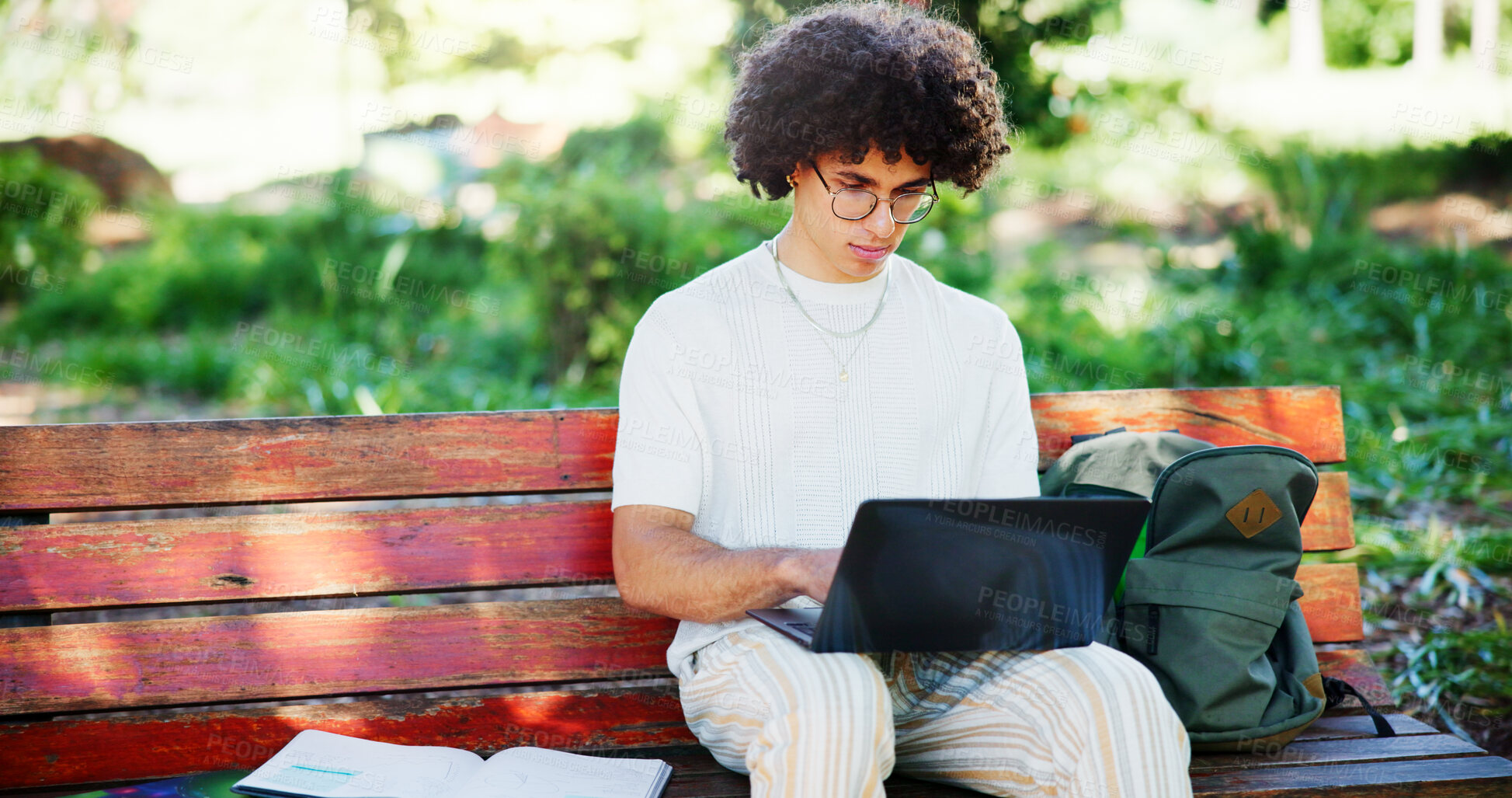 Buy stock photo Man, student and laptop in park for research assignment, university assessment and statistics project. Academic, computer and typing on bench for education, exam preparation and studying in Portugal