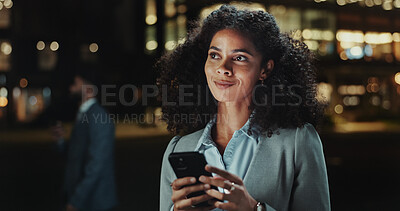 Buy stock photo Business woman, phone and night in city, reading and contact on mobile app for commute in street. Person, smile and thinking with smartphone for notification, text or chat on urban sidewalk in Brazil