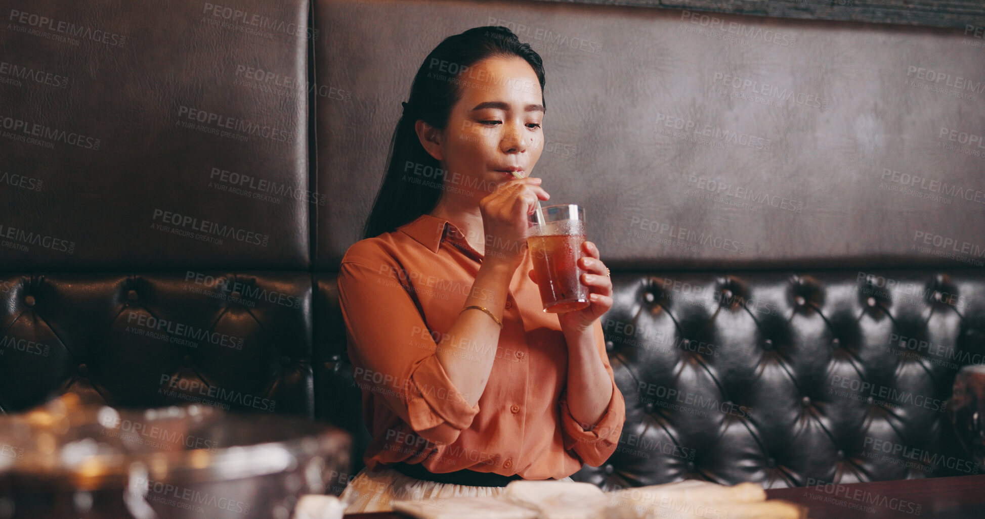 Buy stock photo Woman, restaurant and drinking beverage in Japan, relax and customer in bistro for ice tea. Female person, coffee shop and weekend trip to cafe for lunch, peace and fresh cold caffeine on holiday