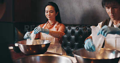 Buy stock photo Couple, cooking and together on date in restaurant for culinary skills, learning and meal prep in bowl. Japanese people, bonding and raw ingredients in cafe for ramen noodles class and experience