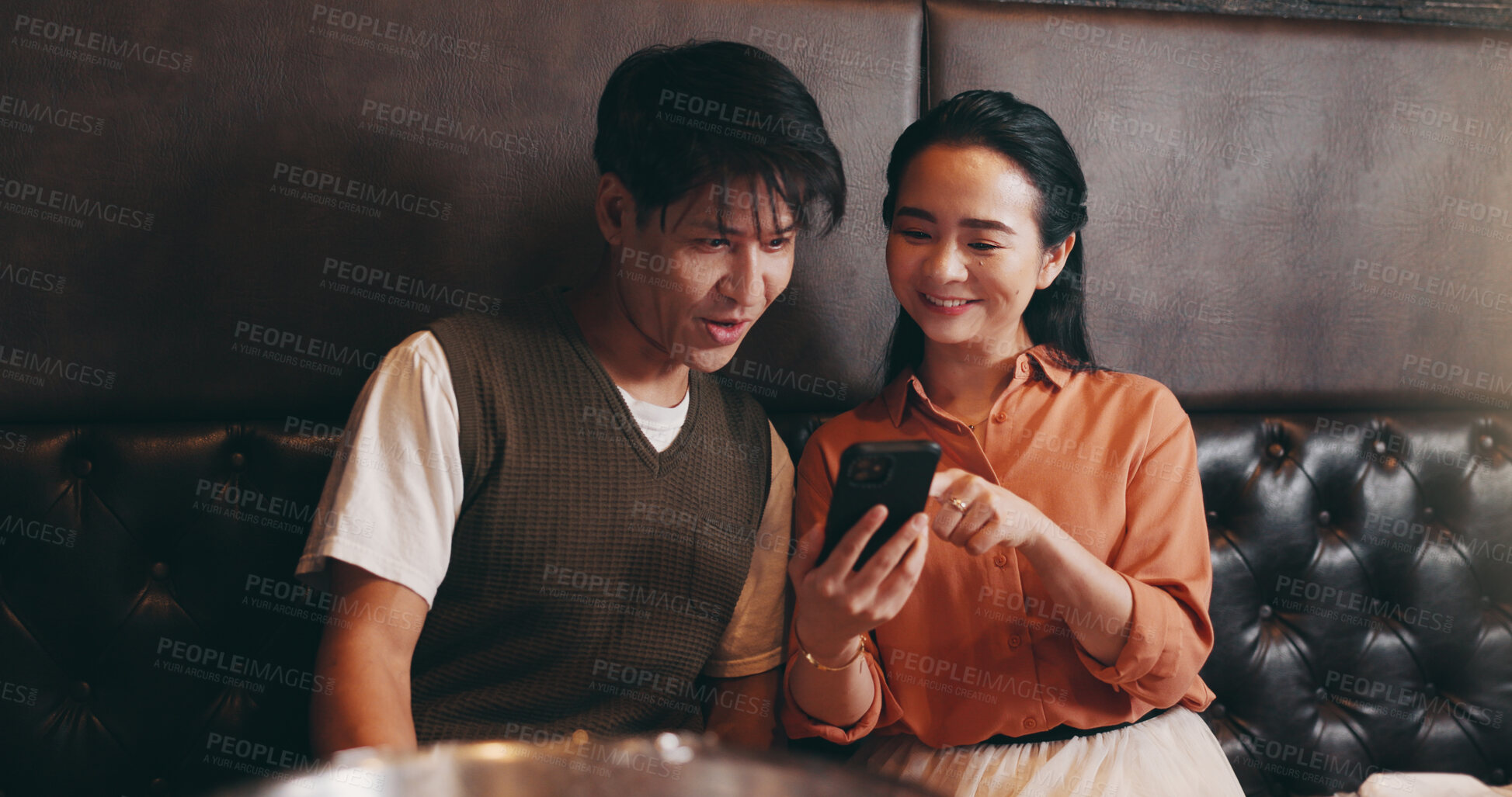 Buy stock photo Japanese, couple and happy with smartphone for restaurant, online menu or service with conversation. Valentines day, man or woman with mobile application for digital order, options or bonding on date