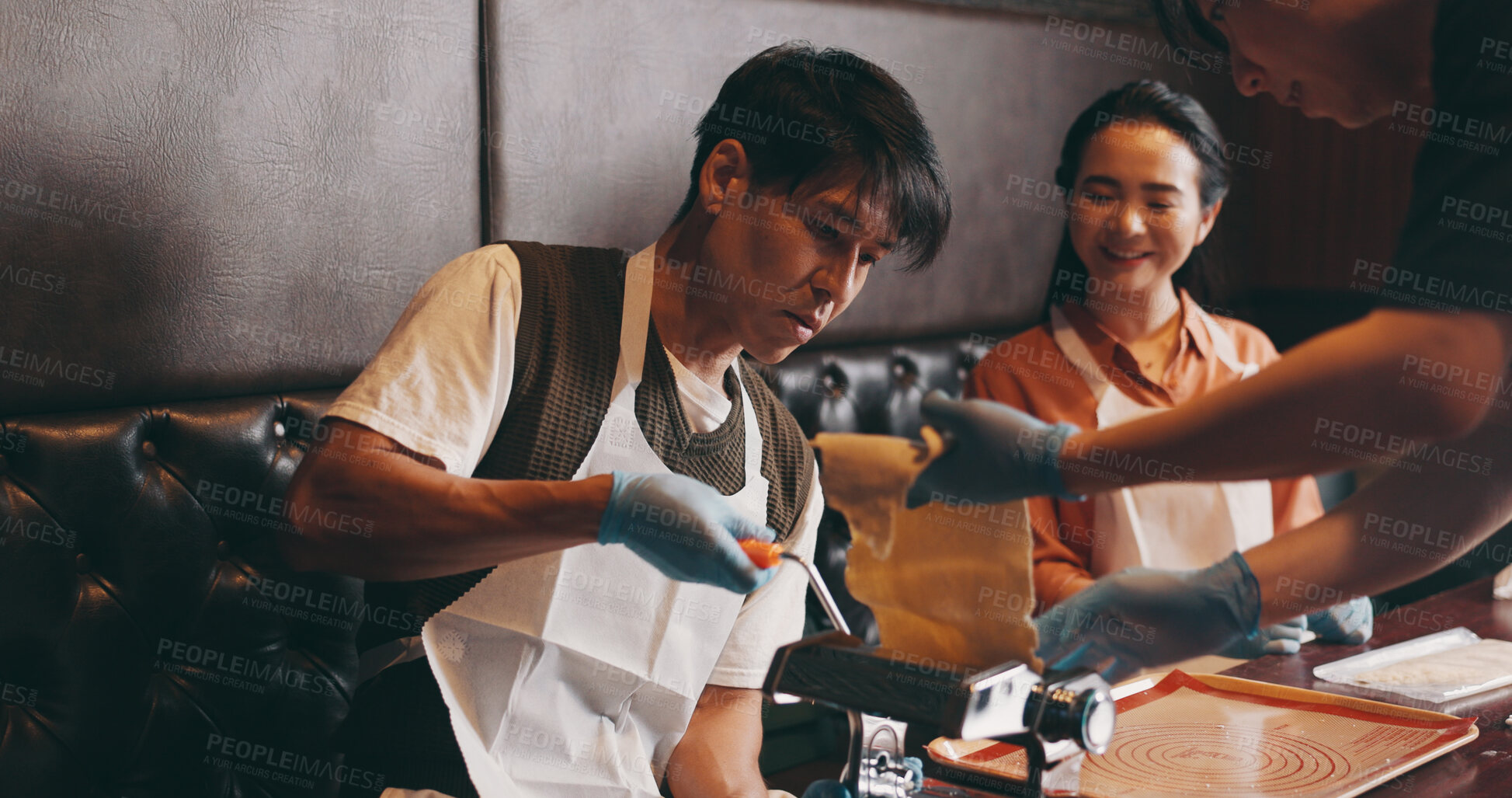 Buy stock photo Cooking, man and woman in class with pasta machine, romantic date and bonding together with food. Couple, learning and making noodles at cafe with smile, love and culinary course in Japanese culture