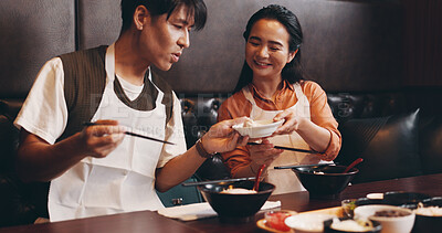 Buy stock photo Eating, date and Japanese couple at restaurant with food, ramen and lunch with smile. Hungry, table and bowl with meal, asian cuisine and customer with chopsticks and health dish for nutrition