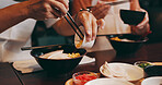 Couple, hands and eating with chopsticks in restaurant for healthy meal, ramen bowl and serving corn vegetables. Japanese people, noodles and food for traditional cuisine, lunch diet and gourmet dish