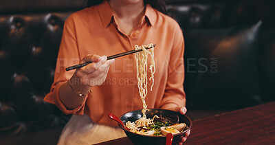 Buy stock photo Hands, woman and eating lunch as hungry in restaurant for nutrition, culture and healthy meal. Female person, hospitality and diet with traditional cuisine, chopsticks and ramen noodles as asian food