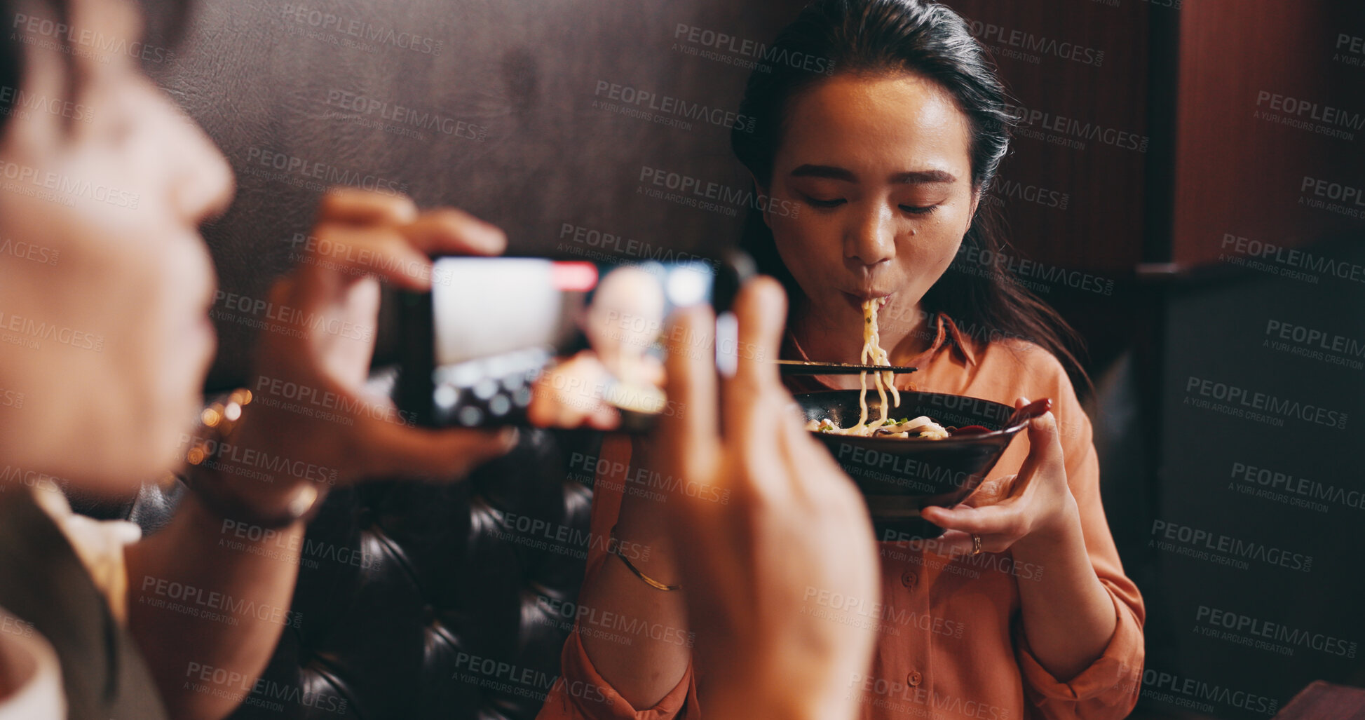 Buy stock photo Couple, food or eating on camera in restaurant for live recording, tasting cuisine or traditional meal vlog. Japanese people, influencer and phone screen for ramen bowl taste test or content creation