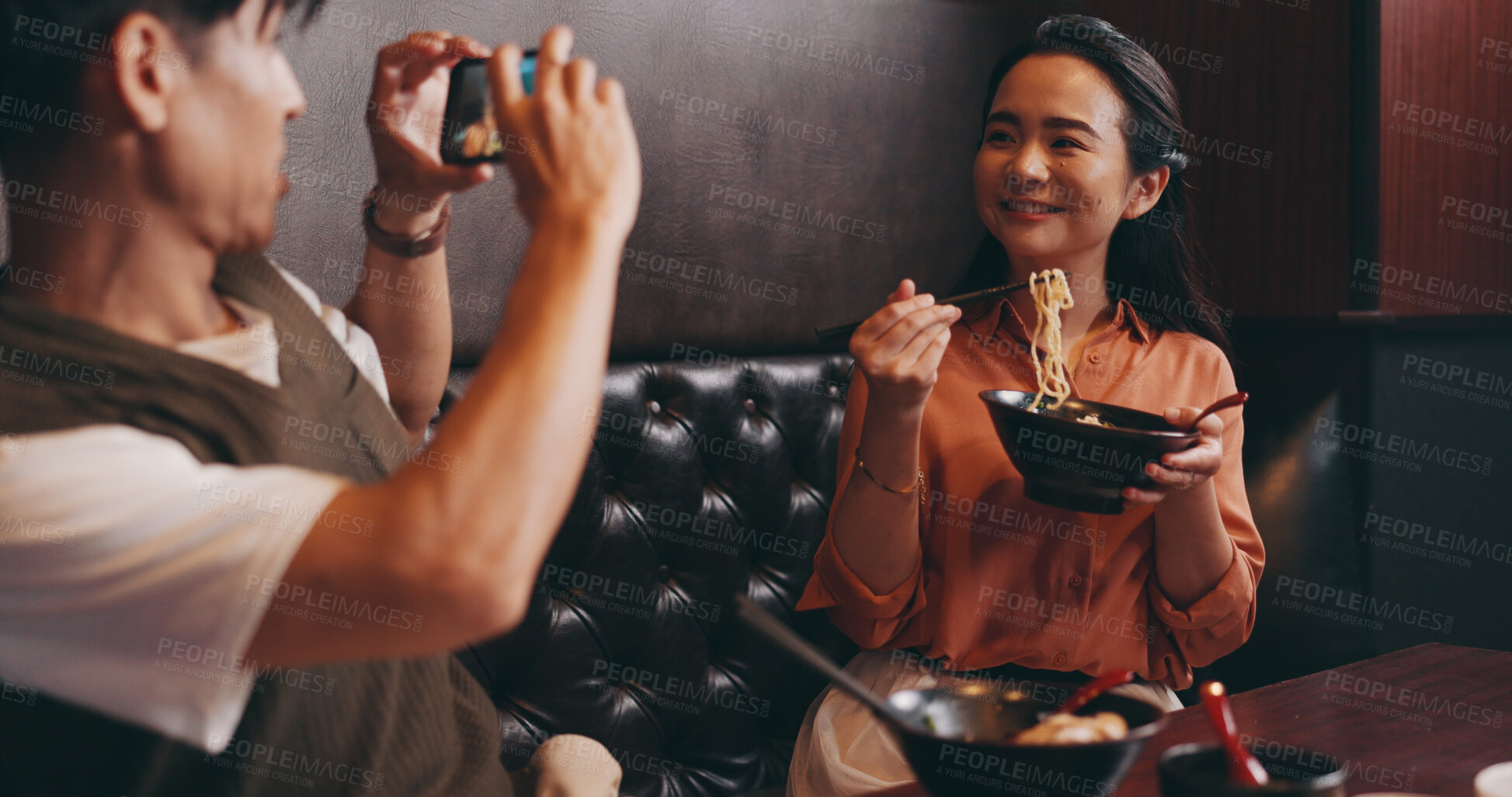 Buy stock photo Couple, food and photo on date in restaurant for happy memory, profile picture update and social media post. Japanese people, ramen bowl and smile with video recording in cafe for bonding and dining