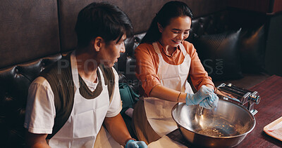 Buy stock photo Cooking, man and woman in class at restaurant with romantic date, bonding together and Asian food. Couple, learning and making noodles at cafe with smile, love and culinary course in Japanese culture