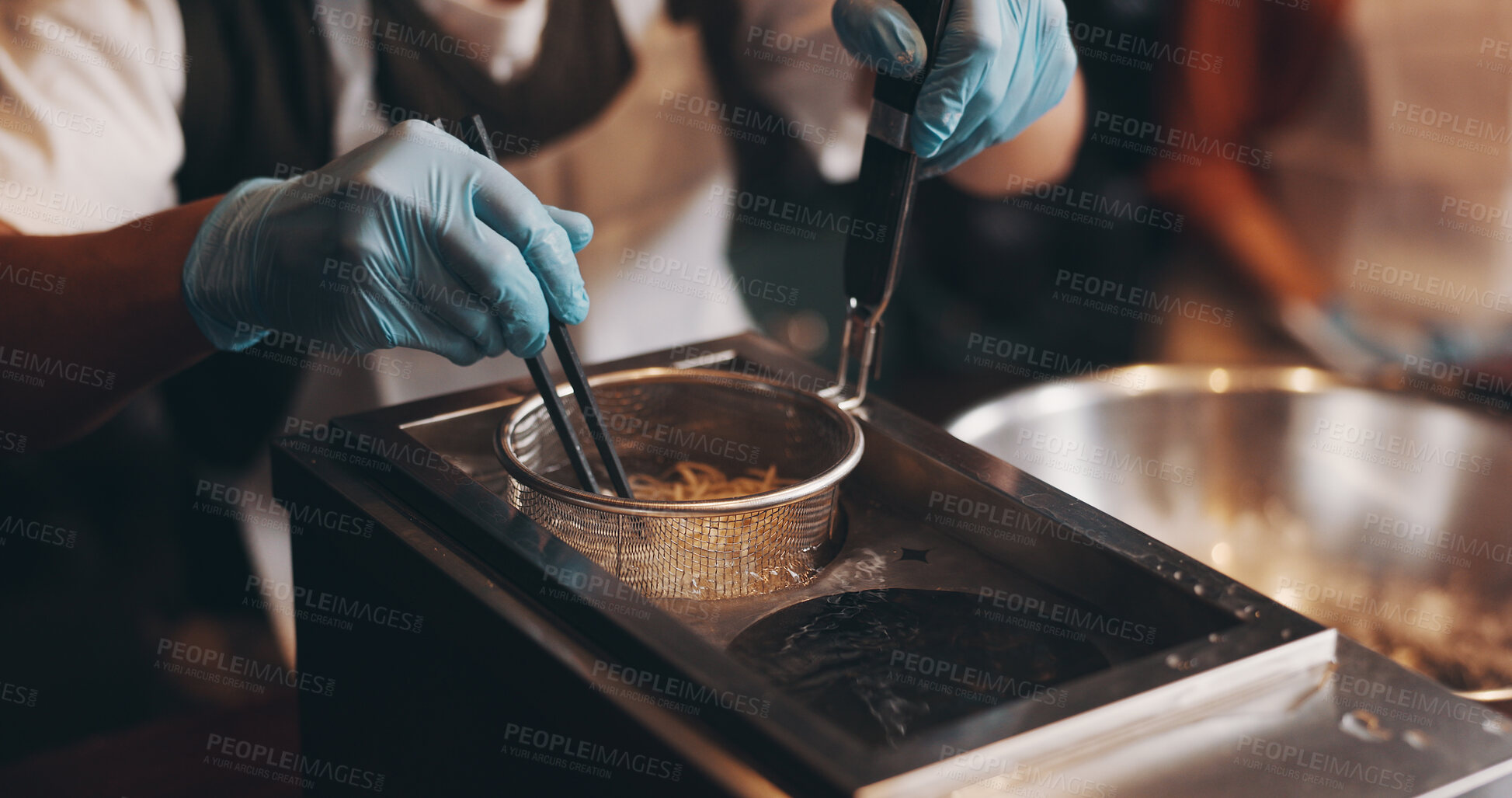 Buy stock photo Japanese restaurant, cooking and hands boiling noodles in kitchen for traditional cuisine, culinary culture and meal prep. Chef, gloves and steaming ramen in strainer for nutrition and healthy dinner