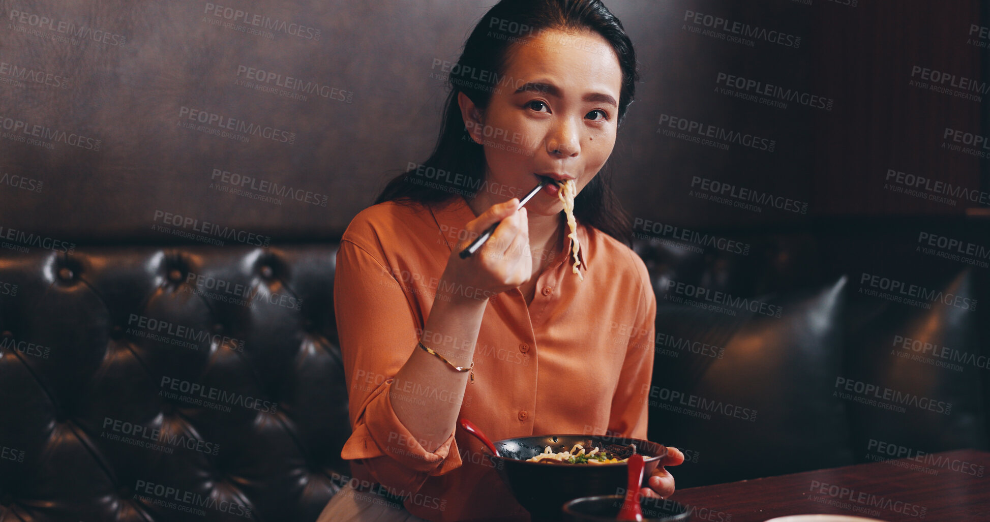 Buy stock photo Portrait, Japanese and woman eating at restaurant for noodles food, nutrition lunch and culture menu. Female person, ramen and traditional cuisine with chopsticks for healthy meal, dinner and Japan