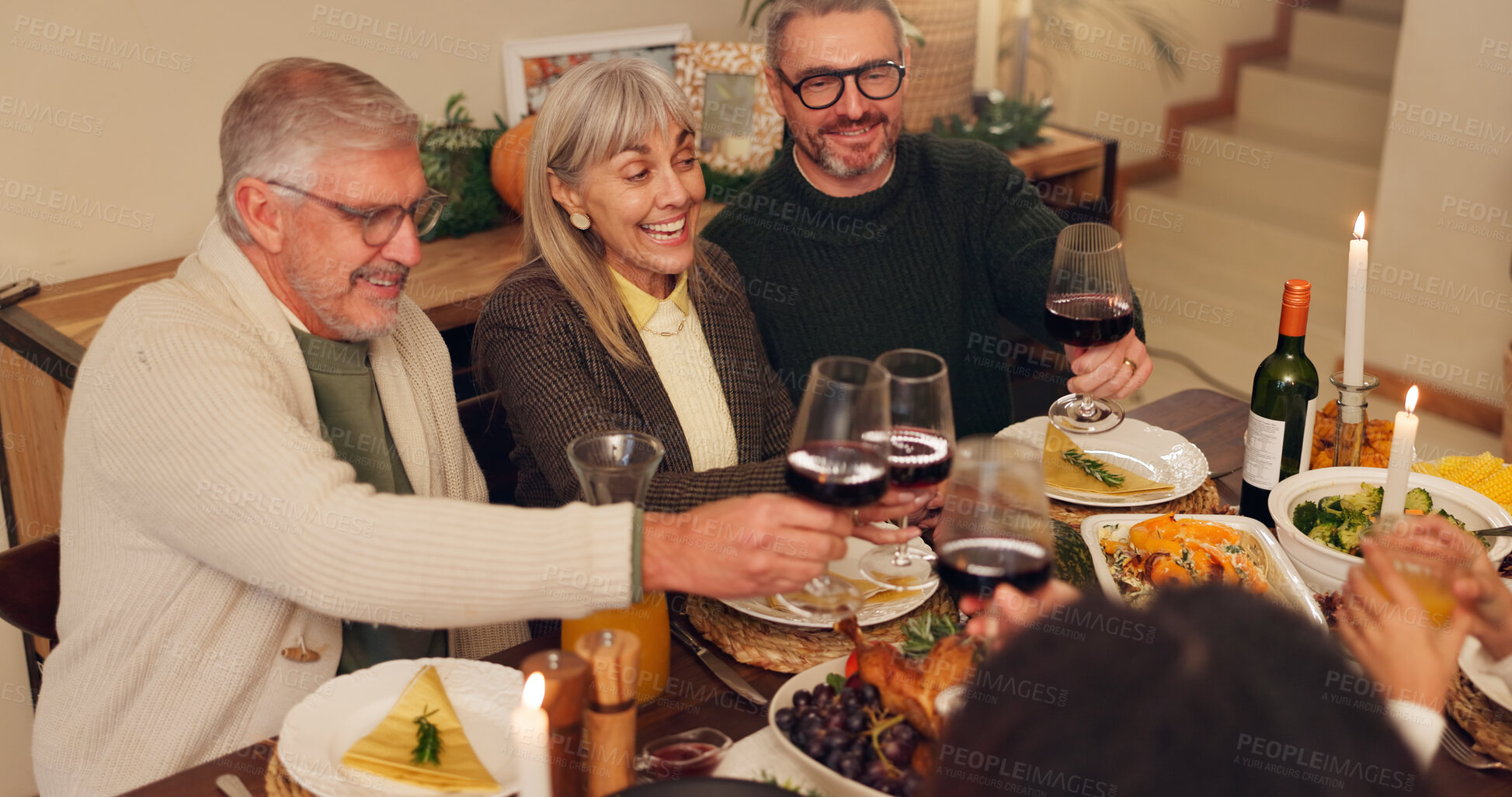 Buy stock photo Big family, celebration and thanksgiving with wine toast for festive holiday, food and vacation. Feast, people and grandparents with care at party, table and nutrition for gathering, event and home
