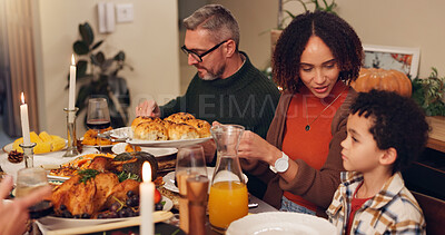 Buy stock photo Happy family, serving and thanksgiving celebration with kids, festive holiday and food for vacation. Feast, people and interracial parents at party, reunion and gathering for dinner or event in home