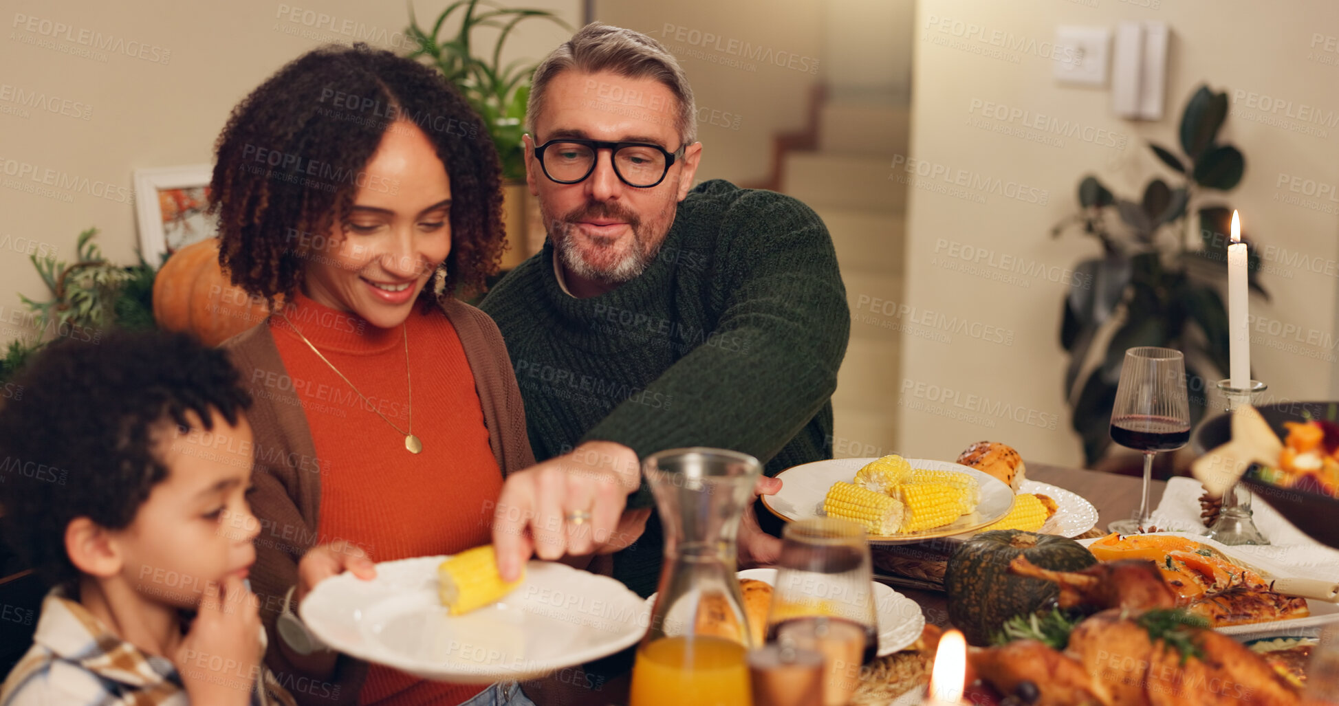 Buy stock photo Home, parents and child with food for thanksgiving, festive feast and holiday celebration as family. House, mother and father with boy with serving for nutrition, corn and bonding with dinner meal