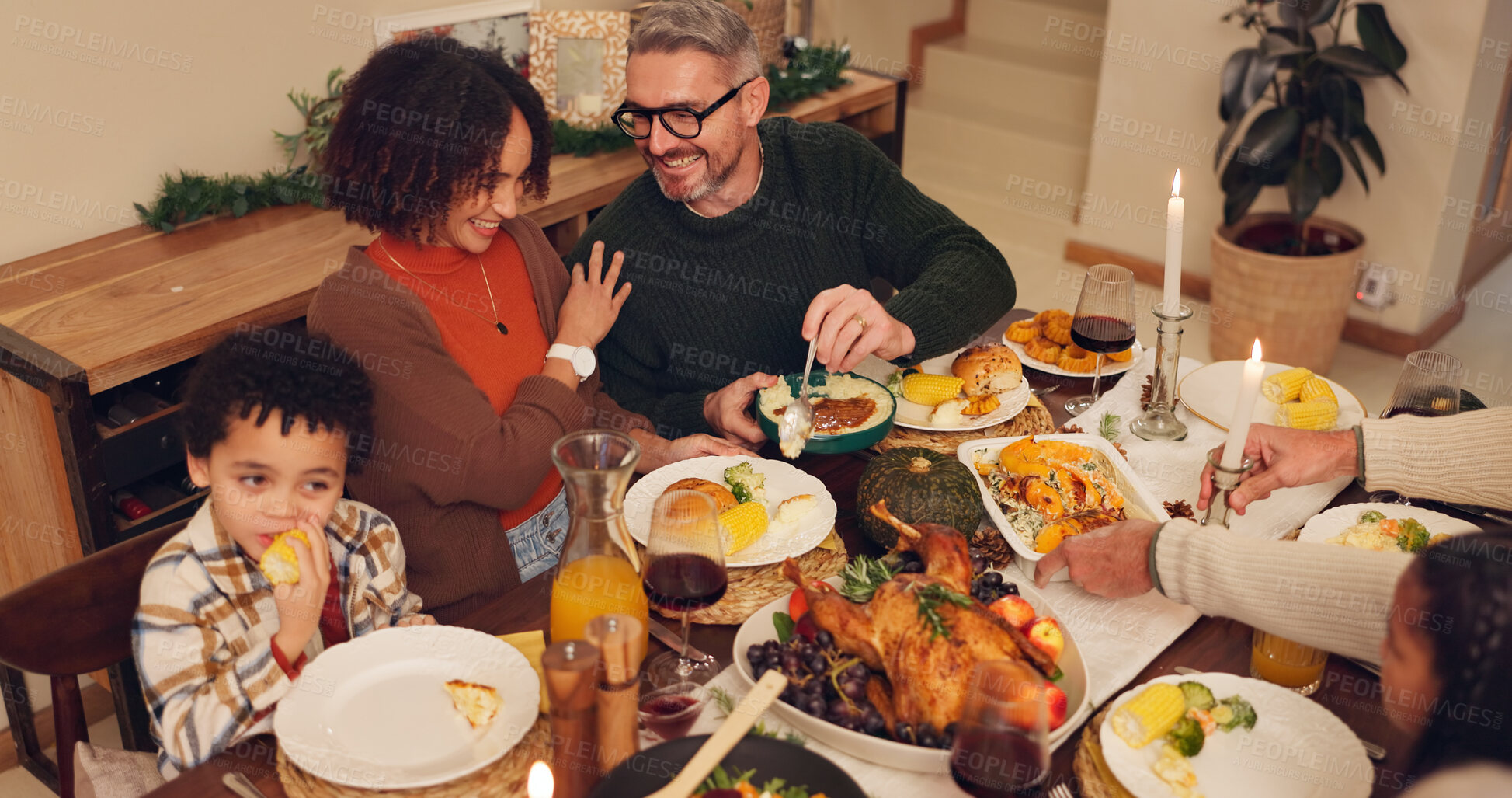 Buy stock photo Happy family, dinner and thanksgiving celebration with kids, festive holiday and food for vacation. Feast, people and interracial parents at party, reunion and gathering for bonding or event in home