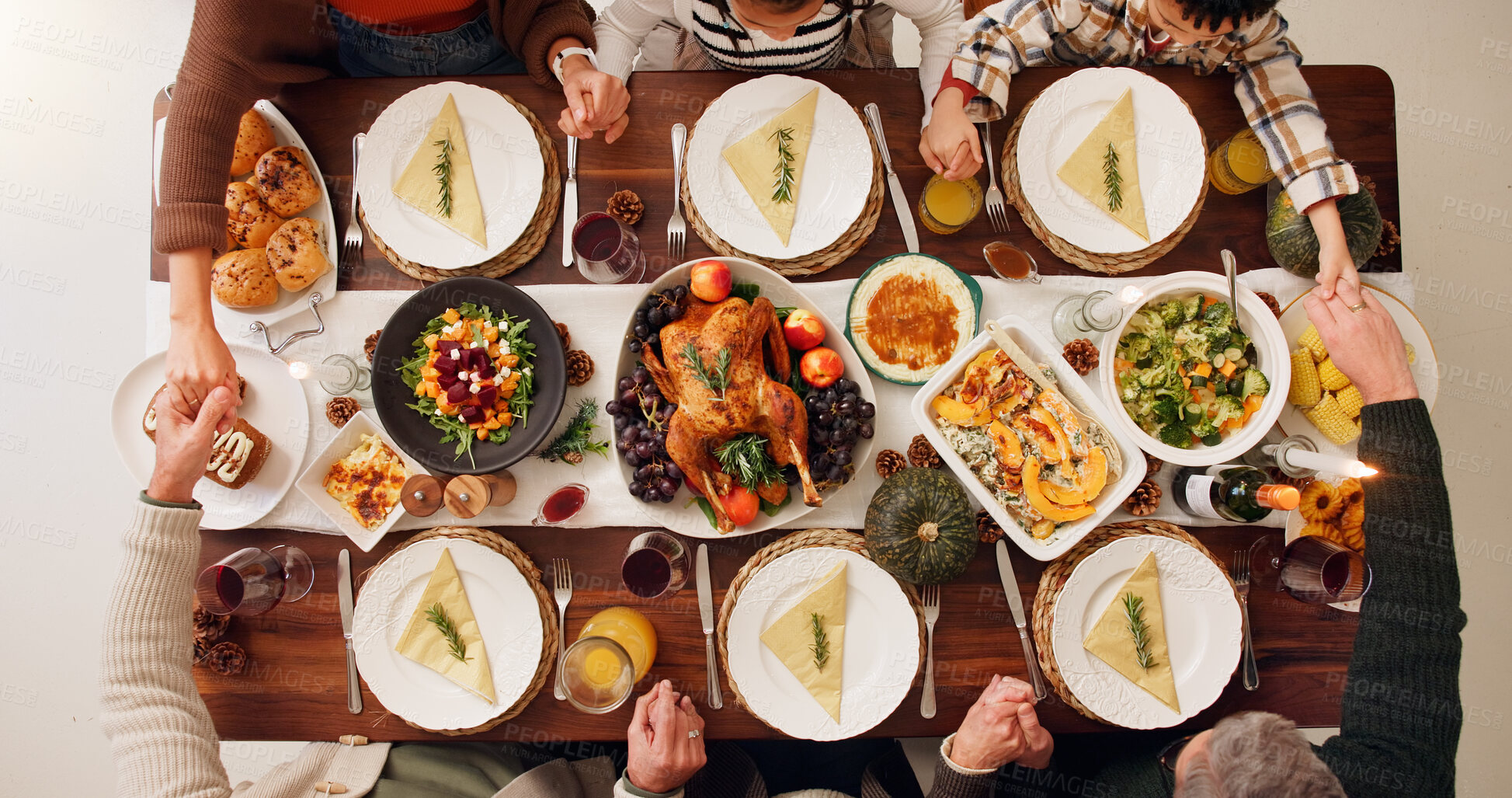 Buy stock photo Above, praying and thanksgiving with family holding hands for celebration, worship and festive holiday. Catering, gratitude and reunion with meal and people at home for dinner, hosting and health