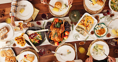 Buy stock photo Above, eating and festive with family and food for celebration, support and thanksgiving holiday. Catering, nutrition and reunion with meal and people at home for dinner, hosting and health together