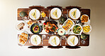 Above, food and thanksgiving with table in dining room for celebration, nutrition and festive holiday. Catering, vegetables and reunion with meal and event at home for dinner, hosting and health