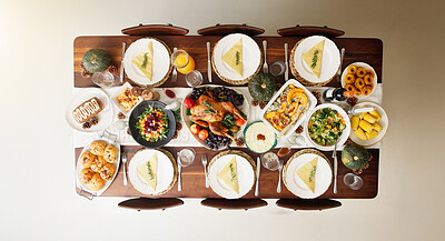 Buy stock photo Above, food and thanksgiving with table in dining room for celebration, nutrition and festive holiday. Catering, vegetables and reunion with meal and event at home for dinner, hosting and health