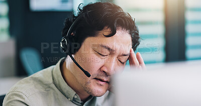 Buy stock photo Call center, business and man in office, headache and stress with burnout, telemarketing and computer. Japanese person, insurance consultant and employee with migraine, overworked or customer support