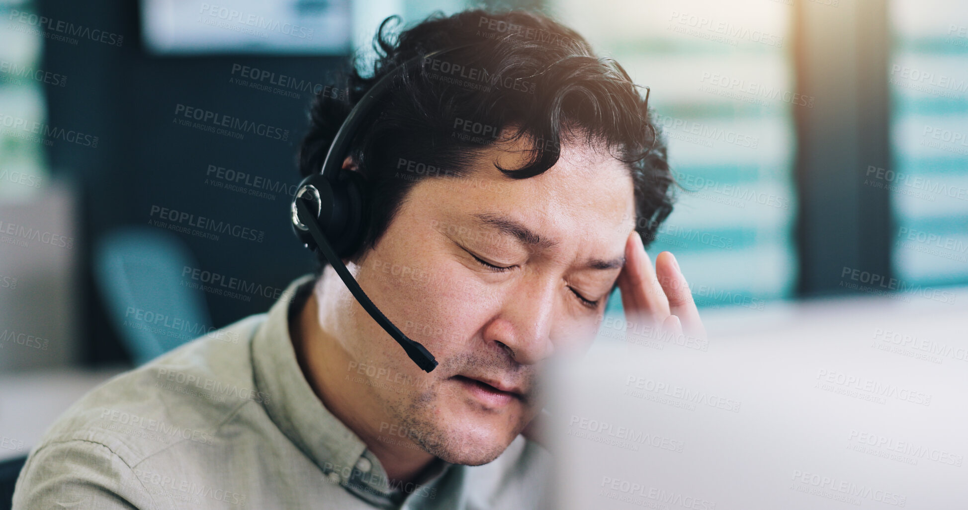 Buy stock photo Call center, business and man in office, headache and stress with burnout, telemarketing and computer. Japanese person, insurance consultant and employee with migraine, overworked or customer support