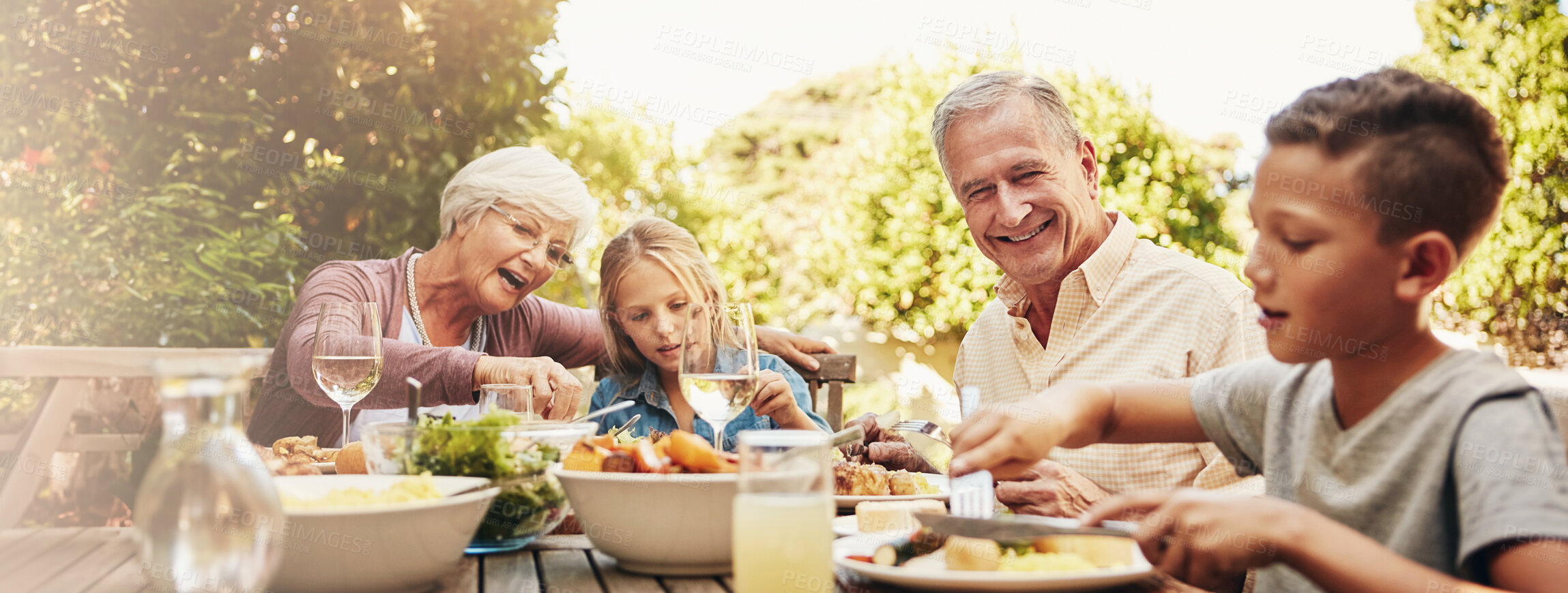 Buy stock photo Happy, lunch and grandparents with children in backyard for brunch, supper or eating food. Family home, banner and grandpa, grandma and kids bonding at Thanksgiving, Christmas or festive garden party