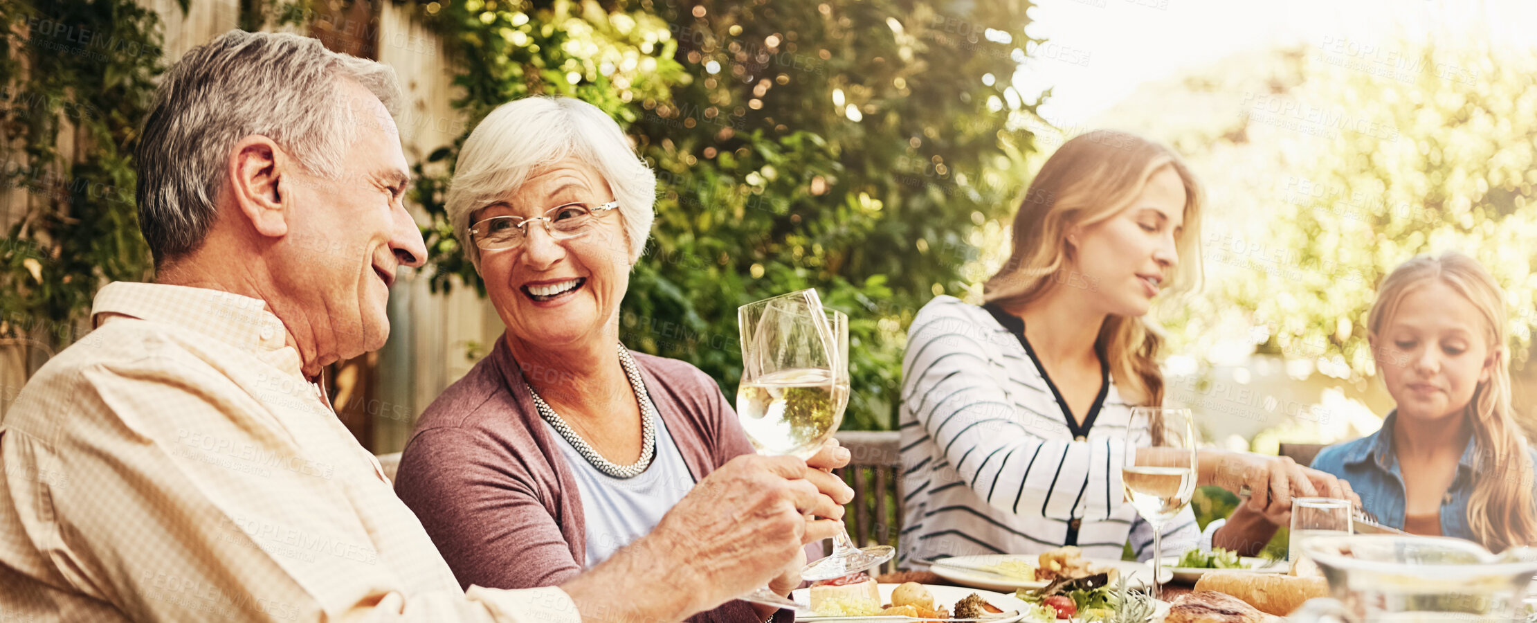 Buy stock photo Happy, lunch and family with children in garden for brunch, dinner and eating together. Banner, grandparents and mom, dad and kids with food for bonding at Thanksgiving, Christmas and festive party